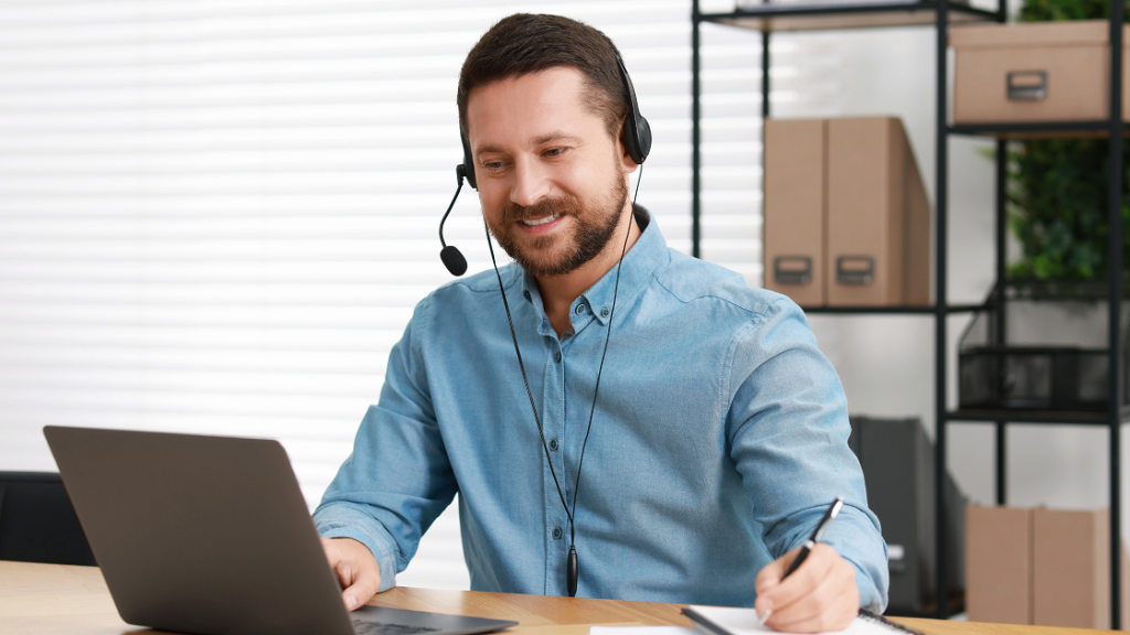 Interpreter participating in a scheduled video remote interpreting (VRI) session using a laptop and headset.