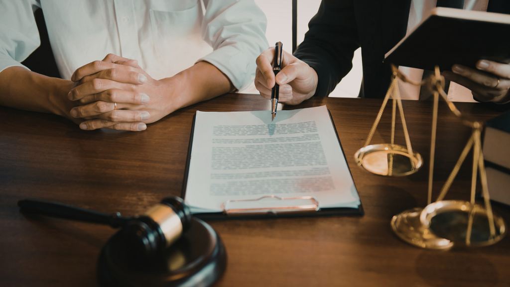 Court-related consultation with documents and gavel, representing accessible legal communication through video remote interpreting (VRI).